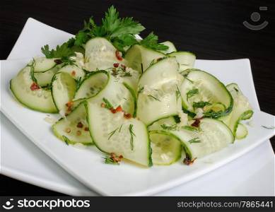 Acute appetizer of fresh cucumbers with garlic, dill, spices