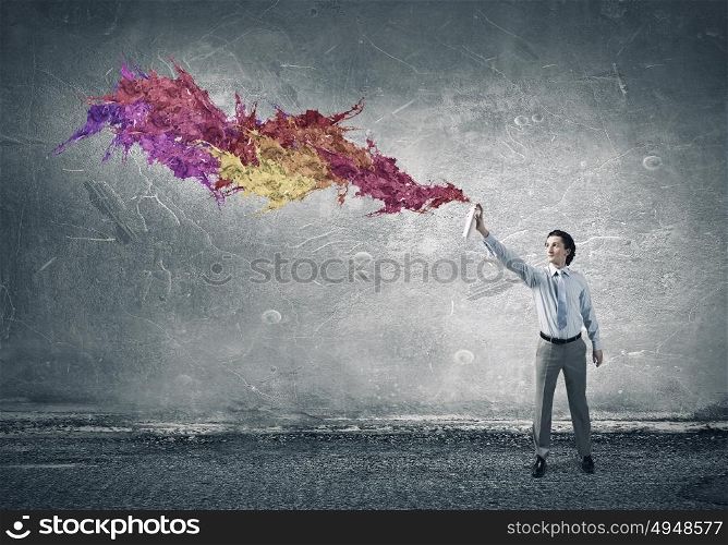 Add more colors to your life. Concept of creativity with businessman spraying paint from balloon