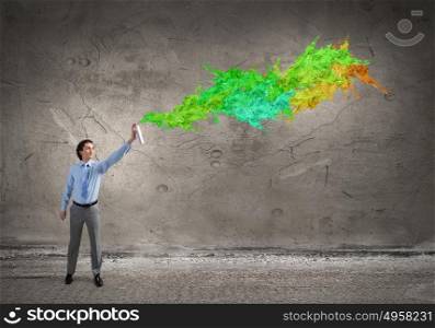 Add more colors to your life. Concept of creativity with businessman spraying paint from balloon