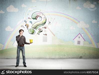 Add some color to your life!. Young man in casual and question marks from bucket