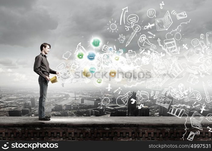 Add some color to your life!. Young man in casual splashing paint from bucket