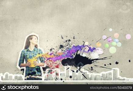 Add some color!. Young girl in casual splashing colorful paint from bucket