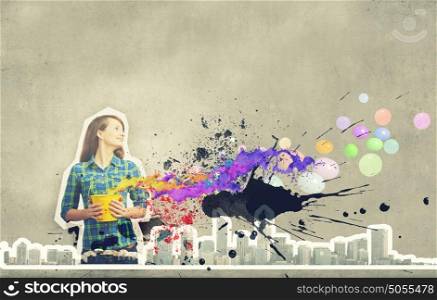 Add some color!. Young girl in casual splashing colorful paint from bucket