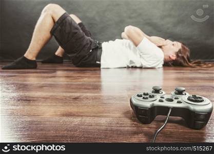 Addiction and dependency concept. Young man with pad joystick playing games. Male addicted to console playstation videogames.. Young man with pad