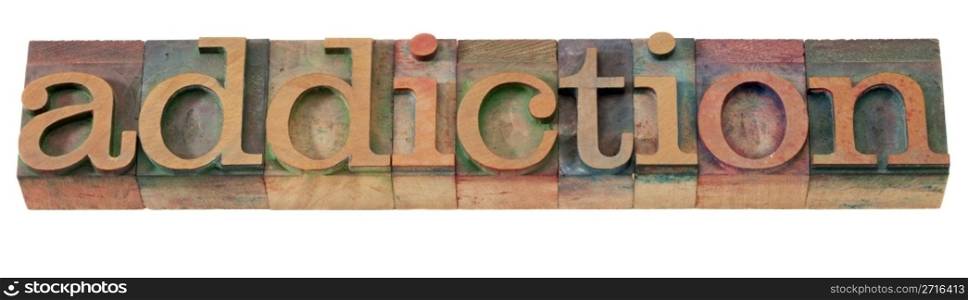 addiction word in vintage wooden letterpress printing blocks, stained by color inks, isolated on white