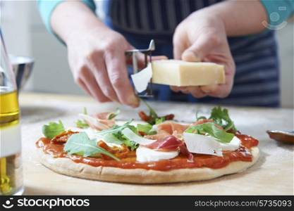 Adding Ingredients To Home Made Pizza