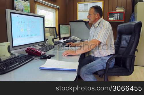 adept engineer work on computer with three monitors