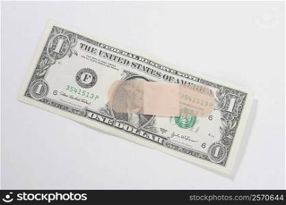 Adhesive bandage on a US dollar bill
