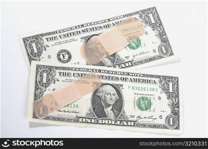 Adhesive tapes on US dollar bills