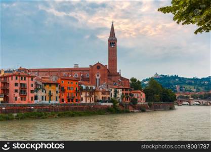 Adige River Embankment and Santa Anastasia Church in cloudy summer day, Verona, Italy