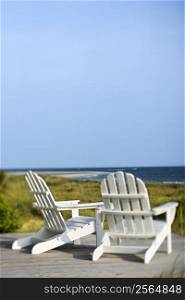 Adirondack chairs on deck looking towards beach on Bald Head Island, North Carolina.