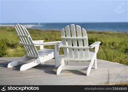Adirondack chairs on deck looking towards beach on Bald Head Island, North Carolina.