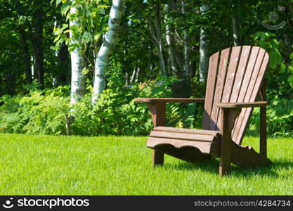 Adirondack summer lawn chair outside on the green grass