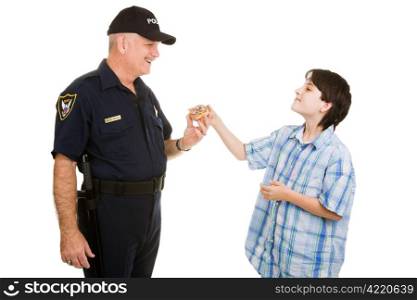Adolescent boy giving a donut to a police officer. Isolated on white.