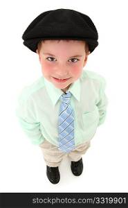 Adorable 3 year old american boy in suit and tie with black kangol looking up over white background.