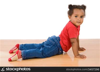 Adorable african baby lying over wooden floor
