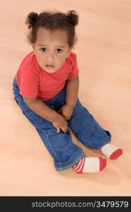 Adorable african baby sit over wooden floor