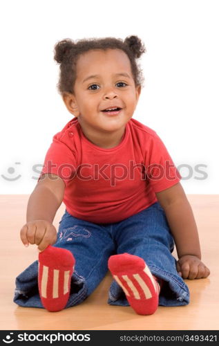 Adorable african baby sit over wooden floor