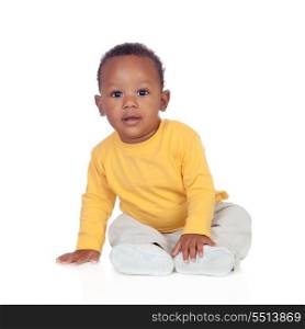 Adorable african baby sitting on the floor isolated on a white background