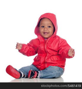 Adorable african baby sitting on the floor with red raincoat isolated on a white background