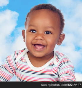 Adorable african baby smiling with a blue sky of background