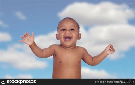 Adorable african baby with a blue sky of background