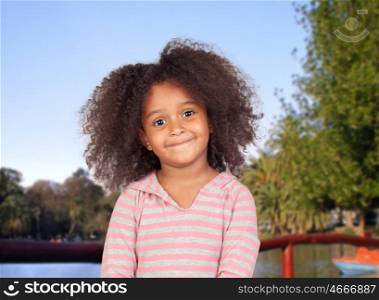 Adorable african little girl with beautiful hairstyle in the park