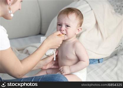 Adorable baby boy eating from spoon