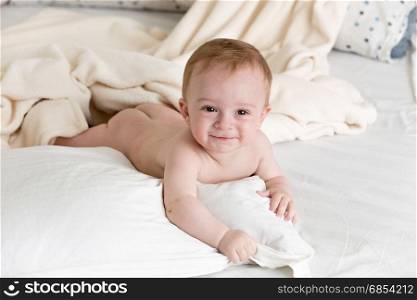 Adorable baby boy lying on white pillow