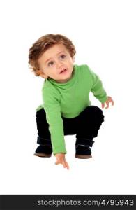 Adorable baby crouching down isolated on a white background
