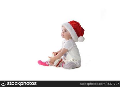 adorable baby girl in Santa hat with gift box