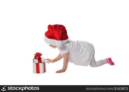 adorable baby girl in Santa hat with gift box
