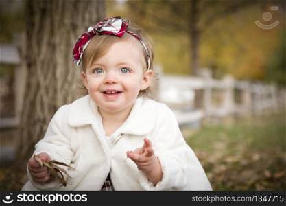 Adorable Baby Girl Playing Outside in the Park.