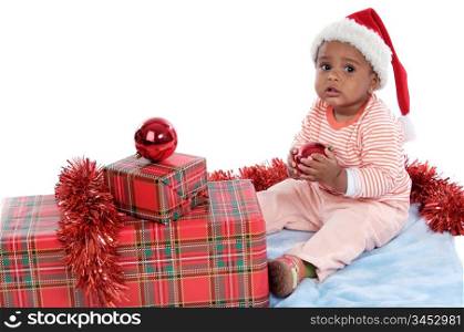 Adorable baby girl with christmas presents and santa hat