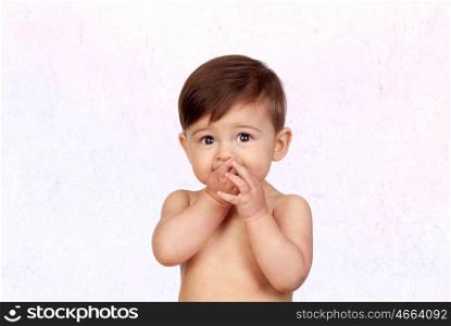 Adorable baby girl with the hands in her mouth