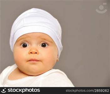 Adorable baby isolated on grey background