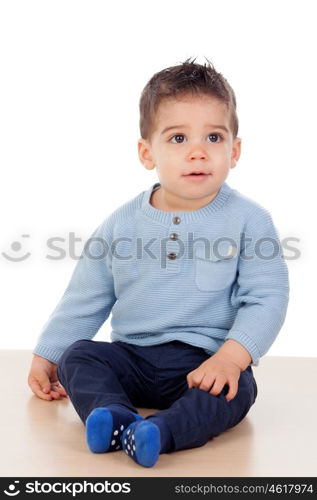 Adorable baby nine months sitting on the floor