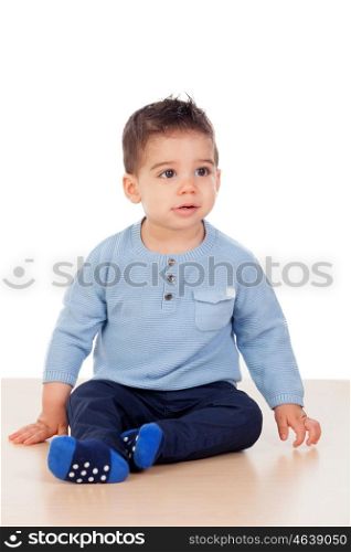 Adorable baby nine months sitting on the floor