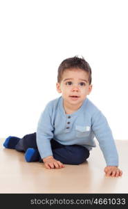 Adorable baby nine months sitting on the floor