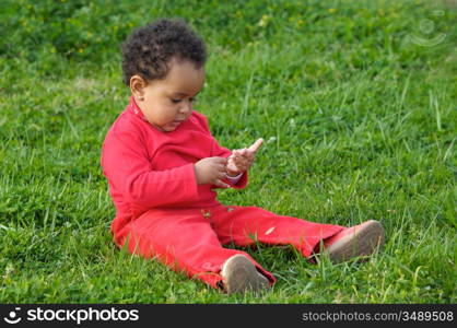 Adorable baby playing on the green grass