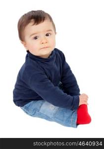 Adorable baby sitting on the floor isolated on a white background