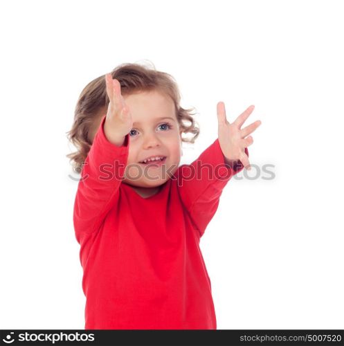 Adorable baby with red shirt pointing with his finger isolated on a white background