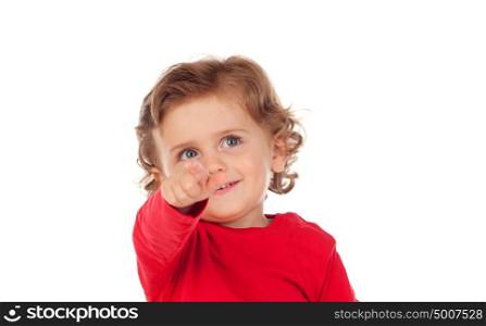 Adorable baby with red shirt pointing with his finger isolated on a white background