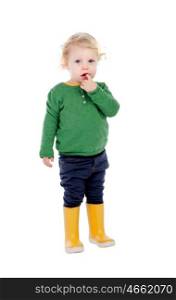Adorable baby with yellow gumboots isolated on a white background
