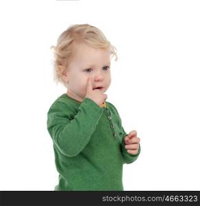 Adorable blond baby indicating his eye isolated on a white background