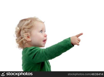 Adorable blond baby indicating something isolated on a white background