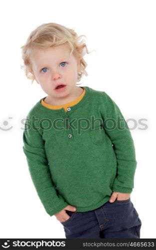 Adorable blond baby with hands in the pockets isolated on a white background