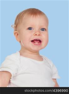 Adorable blonde baby with two small teeth on a blue background