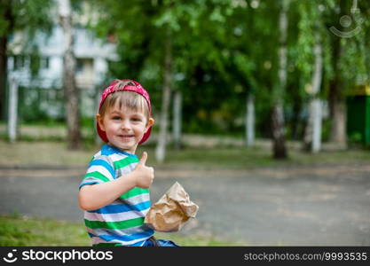 Adorable boy giving thumb up and holding sack of potatoes. Adorable boy giving thumb