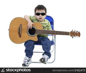 Adorable Boy With Sunglasses And Acoustic Guitar Over White.